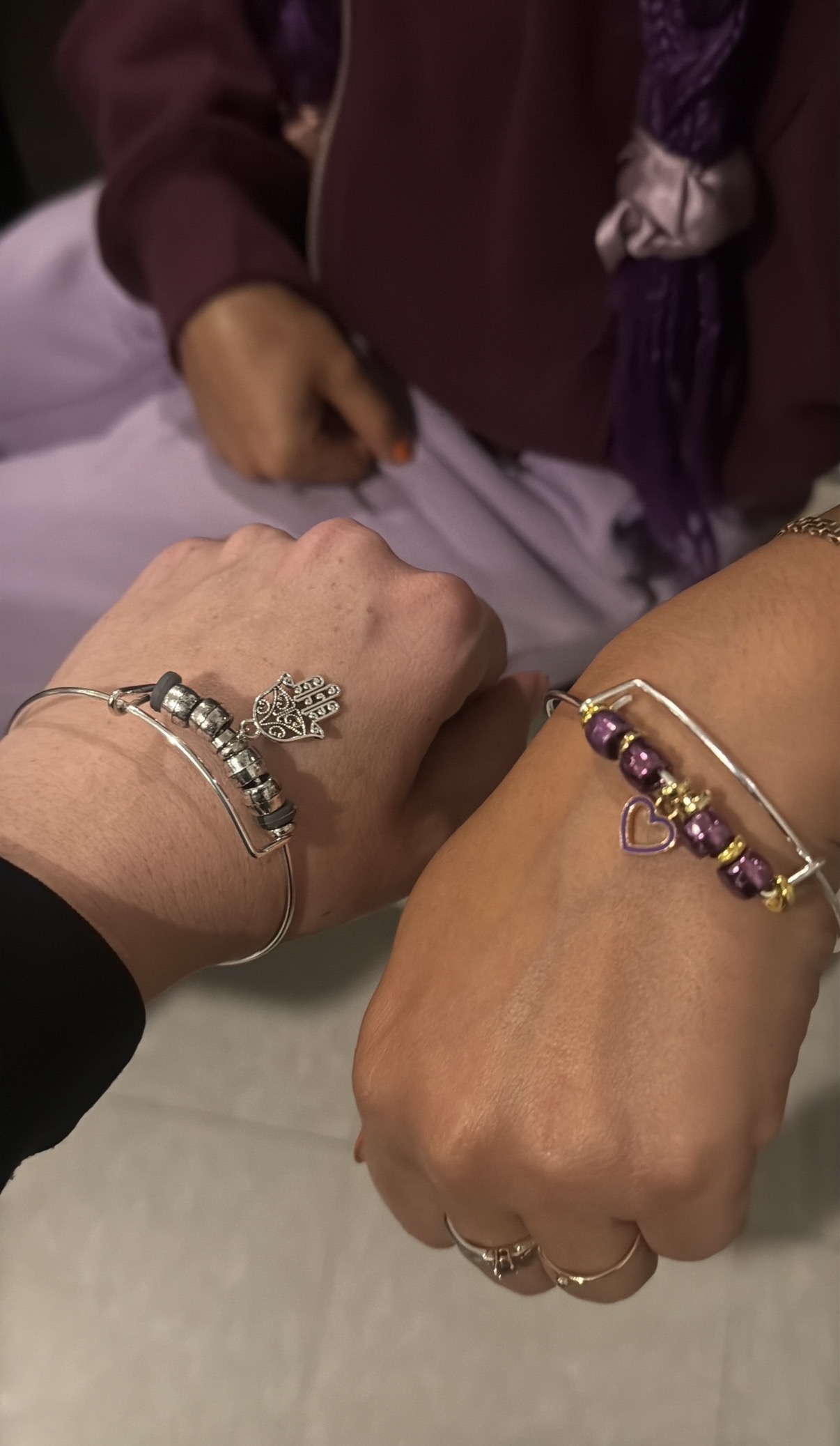 Two guests showing the bracelets they made