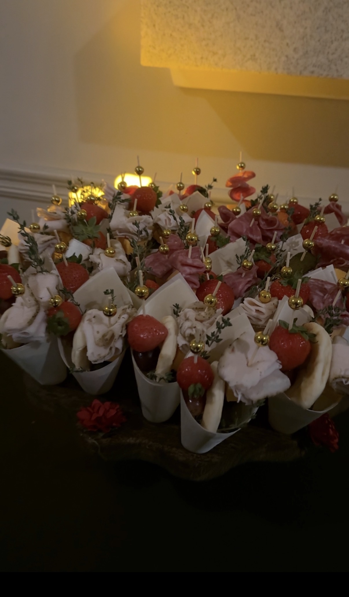 Charcuterie cones topped with strawberries and thyme